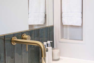 This is an example of a small family bathroom in Other with beige cabinets, a walk-in shower, a wall mounted toilet, green tiles, porcelain tiles, beige walls, a wall-mounted sink, an open shower, a wall niche, a single sink and a floating vanity unit.