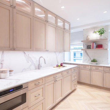 Custom wood cabinetry with marble backsplash and abundant storage