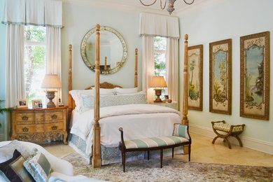Example of a mid-sized eclectic master travertine floor and beige floor bedroom design in Jacksonville with blue walls and no fireplace