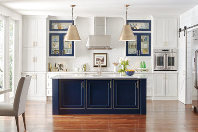 Large transitional single-wall medium tone wood floor and brown floor eat-in kitchen photo in Los Angeles with beaded inset cabinets, white cabinets, white backsplash, stainless steel appliances, an island and white countertops