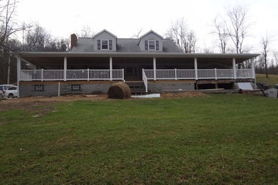 Inspiration for a large timeless gray two-story gable roof remodel in Other with a shingle roof