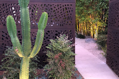 Mid-sized modern front yard partial sun xeriscape in Los Angeles with with a gate and gravel.