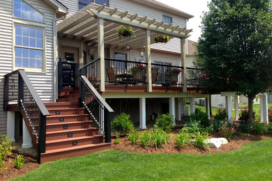Inspiration for a large traditional backyard deck in Chicago with a pergola.