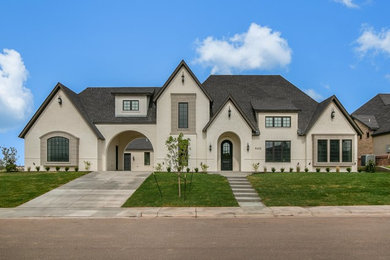 Inspiration for a large transitional white two-story brick exterior home remodel in Austin with a shingle roof