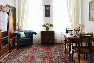 Example of a small classic enclosed medium tone wood floor and brown floor living room design in Other