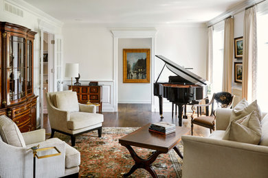 Example of a classic formal medium tone wood floor living room design in Chicago with white walls