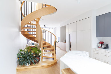 Design ideas for a mid-sized contemporary wood spiral staircase in Melbourne with open risers and wood railing.