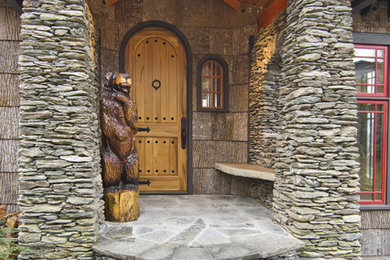 Example of a classic single front door design in Raleigh with a medium wood front door