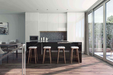 Kitchen - mid-sized modern single-wall dark wood floor and brown floor kitchen idea in Montreal with flat-panel cabinets, white cabinets, solid surface countertops, gray backsplash, quartz backsplash, stainless steel appliances and black countertops