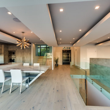 Kitchen and Dining Level with Open Stair Behind a Glass Rail