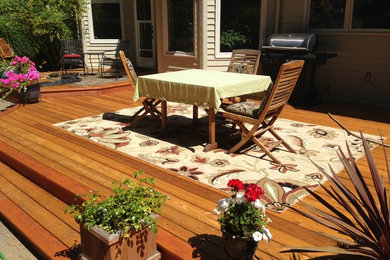 This is an example of a large arts and crafts backyard deck in Portland.