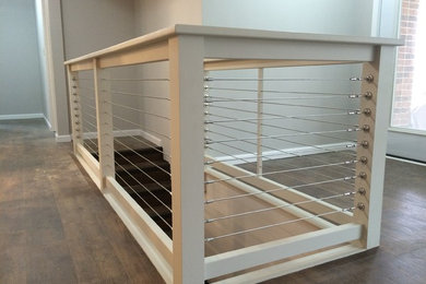 Inspiration for a mid-sized industrial wooden straight mixed material railing staircase remodel in St Louis with wooden risers