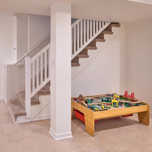 Inspiration for a medium sized traditional walk-out basement in Seattle with white walls, lino flooring, a standard fireplace and multi-coloured floors.