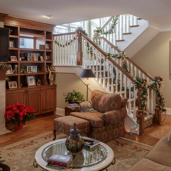 Example of a mid-sized arts and crafts open concept and formal medium tone wood floor, brown floor, wallpaper ceiling and wallpaper living room design in Detroit with beige walls, a standard fireplace