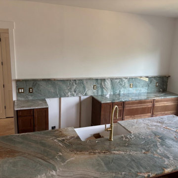 Green quartzite kitchen with full-height slab backsplash