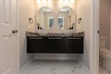 Minimalist master porcelain tile, white floor and double-sink bathroom photo in Charlotte with flat-panel cabinets, black cabinets, a vessel sink, granite countertops and a floating vanity