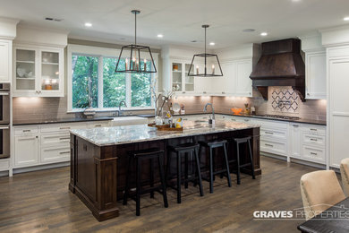 Inspiration for a large transitional l-shaped medium tone wood floor eat-in kitchen remodel in Minneapolis with a farmhouse sink, shaker cabinets, white cabinets, quartz countertops, brown backsplash, ceramic backsplash, stainless steel appliances and an island