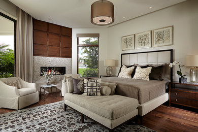 Inspiration for a mid-sized modern master medium tone wood floor and brown floor bedroom remodel in Miami with a ribbon fireplace and a tile fireplace