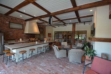 Sunroom - large industrial brick floor sunroom idea in New Orleans with a standard fireplace and a standard ceiling