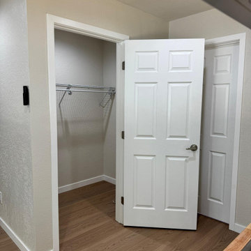 Bright Primary Suite with Wood-Look Flooring