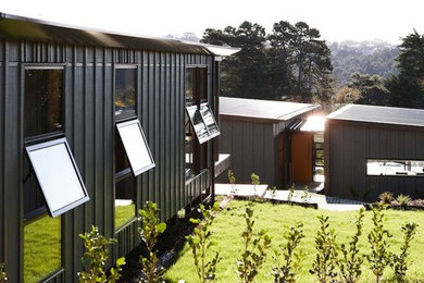 Small contemporary one-storey green exterior in Auckland.