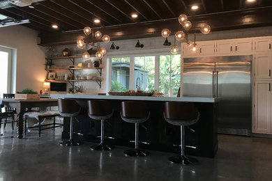 Inspiration for a huge farmhouse galley concrete floor and gray floor open concept kitchen remodel in Orlando with recessed-panel cabinets, white cabinets, quartzite countertops, white backsplash, subway tile backsplash, stainless steel appliances, an island and white countertops