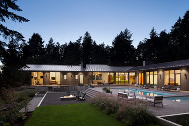 Design ideas for a large midcentury courtyard rectangular lap pool in Portland with a hot tub and concrete slab.