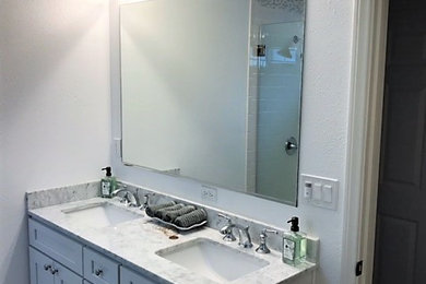 Bathroom - small coastal master white tile and ceramic tile dark wood floor and brown floor bathroom idea in Orange County with shaker cabinets, white cabinets, gray walls, an undermount sink, marble countertops and gray countertops