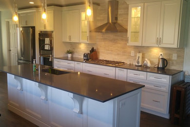 Mid-sized transitional galley vinyl floor and gray floor eat-in kitchen photo in Salt Lake City with a farmhouse sink, recessed-panel cabinets, white cabinets, quartz countertops, beige backsplash, limestone backsplash, stainless steel appliances and an island