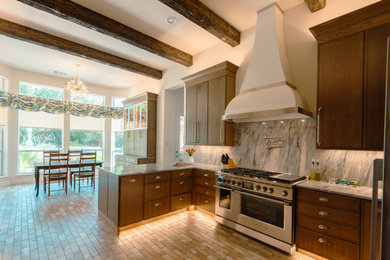 Example of a large transitional u-shaped brick floor, brown floor and exposed beam eat-in kitchen design in Austin with shaker cabinets, medium tone wood cabinets, quartzite countertops, blue backsplash, stainless steel appliances, a peninsula and blue countertops