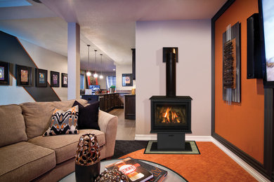 Living room - mid-sized modern formal and enclosed living room idea in Other with beige walls, a wood stove and a wall-mounted tv