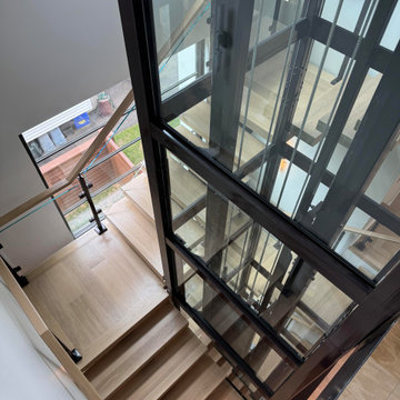 Project #136 | Modern Floating Staircase Encircling Glass Elevator