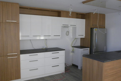 Inspiration for a small kitchen remodel in Other with flat-panel cabinets and laminate countertops