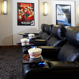 This is an example of a large rustic enclosed home cinema in St Louis with white walls, carpet and a projector screen.