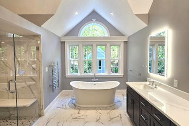 Example of a large transitional master porcelain tile, gray floor, double-sink and vaulted ceiling bathroom design in Boston with furniture-like cabinets, dark wood cabinets, gray walls, an undermount sink, quartz countertops, a hinged shower door, white countertops and a freestanding vanity