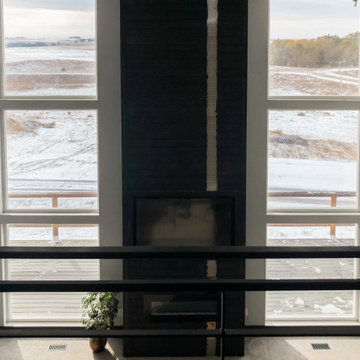 Three square windows stacked with custom fireplace