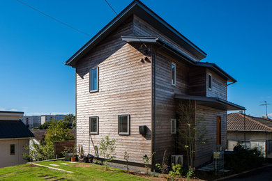 Contemporary exterior in Other with wood siding, a shed roof, a metal roof and clapboard siding.