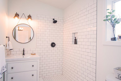 Example of a mid-sized minimalist 3/4 white tile and subway tile ceramic tile and multicolored floor bathroom design in Portland with furniture-like cabinets, white cabinets, a two-piece toilet, white walls, an integrated sink, solid surface countertops and white countertops