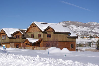 Example of a huge brown two-story wood exterior home design in Denver