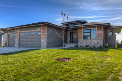 Large transitional brown two-story mixed siding exterior home idea in Other with a shingle roof