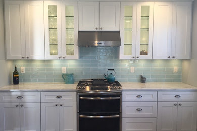 Inspiration for a mid-sized traditional single-wall eat-in kitchen in Philadelphia with shaker cabinets, white cabinets, marble benchtops, blue splashback, subway tile splashback, stainless steel appliances and no island.