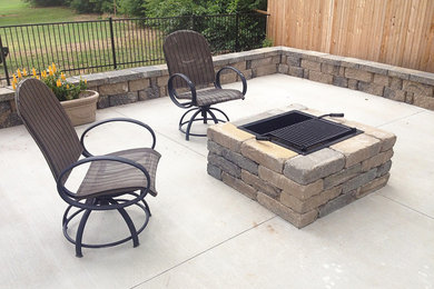 Inspiration for a mid-sized traditional backyard patio in Other with a fire feature, concrete slab and no cover.
