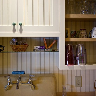 Mid-sized beach style kitchen pantry appliance - Inspiration for a mid-sized beach style kitchen pantry remodel in Manchester with a farmhouse sink, beaded inset cabinets, white cabinets, granite countertops and an island