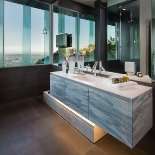 Example of a trendy black tile black floor bathroom design in Los Angeles with flat-panel cabinets, gray cabinets, black walls, an integrated sink and white countertops