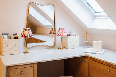 Photo of a small modern master and grey and pink loft bedroom in Buckinghamshire with pink walls, carpet, no fireplace and grey floors.