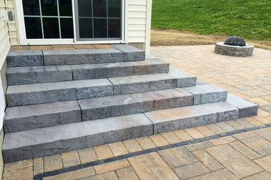 Mid-sized transitional side yard patio in New York with natural stone pavers and no cover.