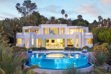 Inspiration for a large contemporary backyard custom-shaped pool remodel in Los Angeles