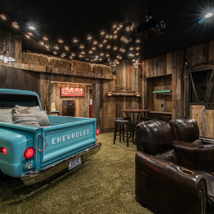 Design ideas for a rustic enclosed home cinema in Charlotte with brown walls, carpet and green floors.