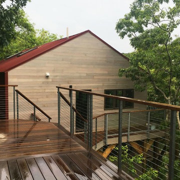 Transformed approach, siding, roofing, entry and decks.