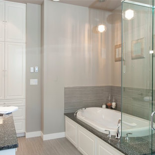 Example of a large trendy master gray tile and porcelain tile porcelain floor bathroom design in Vancouver with an undermount sink, raised-panel cabinets, white cabinets, engineered quartz countertops, a two-piece toilet and gray walls
